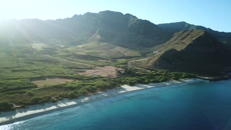 Drone-Shot-showing-the-beautiful-Makua-Valley-and-Makua-Beach-at-sunrise-on-Oahu,-Hawaii