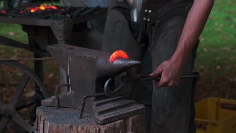 Blacksmith-shop,-male-hands-with-hammer-forging-a-heart-of-iron