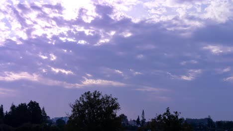 4k-time-lapse-of-morning-sunrise-behind-clouds,-beautiful-purple-pink-hue,-shot-in-Marbella,-Malaga,-Spain