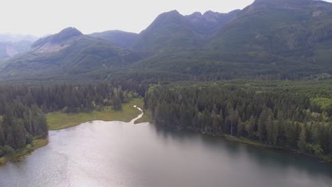 Aerial-pan-over-small-lake-in-the-rugged-mountains