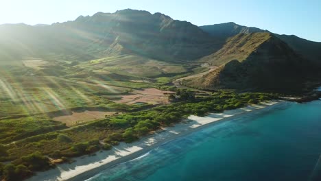 Drone-Shot-showing-the-beautiful-Makua-Valley-and-Makua-Beach-at-sunrise-on-Oahu,-Hawaii