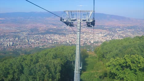 Panoramic-view-of-an-urban-town-from-a-cable-car-in-the-mountains