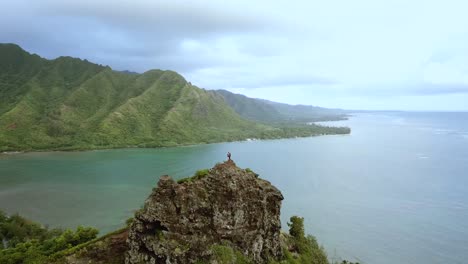 Drohnenschuss,-Der-Ein-Paar-Wanderer-Umkreist,-Die-Auf-Der-Spitze-Der-Klippen-Auf-Der-Kauernden-Löwenwanderung-Auf-Oahu,-Hawaii,-Stehen