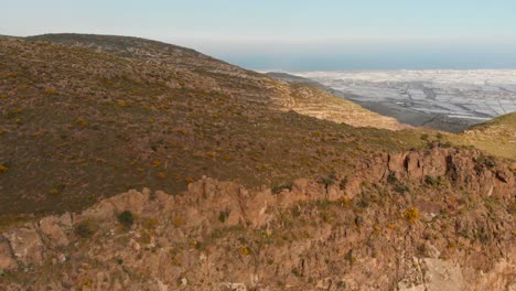 Die-Berge-Bei-Almeria-Im-Süden-Spaniens-Mit-Den-Gewächshäusern-Im-Hintergrund,-Luftaufnahme