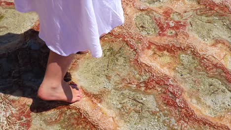 Girl-walking-on-the-marble-of-the-natural-landmark-of-Turkey-Pamukkale