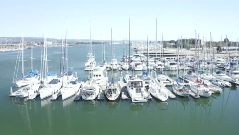 Slow-rise-to-reveal-multiple-sail-boats-and-large-marina