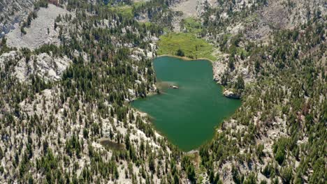 Aerial-of-Crystal-Lake-and-its-snowy-mountains-in-the-summer,-Mammoth-Lakes-in-4K