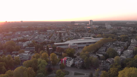 Aerial-view-the-Dutch-medieval-city-of-Utrecht-at-sunrise-with-the-white-modern-building-of-the-railroad-museum-among-the-traditional-homes
