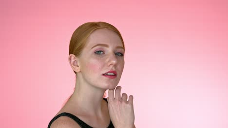 Beautiful-redhead-woman-against-pink-background