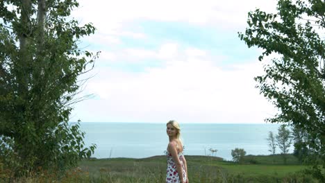 A-young-beautiful-blonde-woman-admiring-the-nature-and-happily-running-towards-the-camera