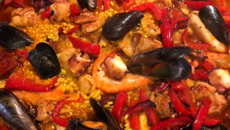 Close-up-of-home-made-traditional-Spanish-paella-cooking,-seafood-dish-with-rice