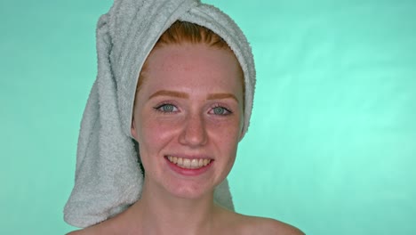 Redhead-woman-with-freckles-standing-with-towel-on-head