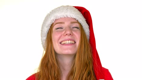 Static-medium-close-up-shot-of-a-cute-redhead-lady-wearing-a-Santa-hat-and-smiling
