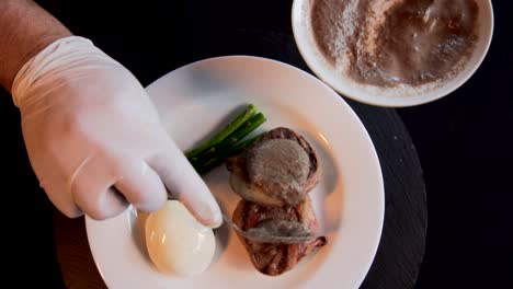 A-hands-of-chef-putting-gravy-in-a-filet-mignon