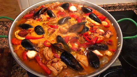 Cooking-seafood-Paella-at-home,-traditional-Spanish-paella-with-prawns,-mussels-and-fish