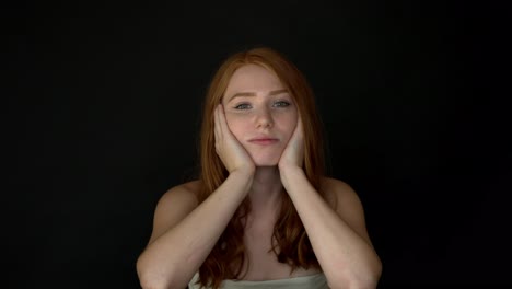 Bored-redhead-woman-looking-at-camera