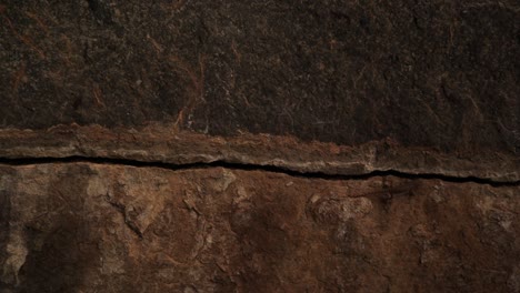 Close-up-sliding-shot-of-Scary-Cracked-Rock-stone-inside-the-cave-after-hitting-by-the-thunderbolt