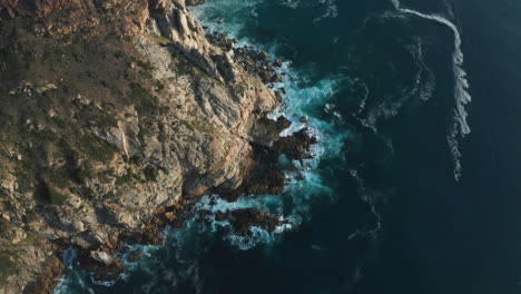 Aerial-Orbit-of-Big-Waves-Crashing-against-Rocks-in-Ocean