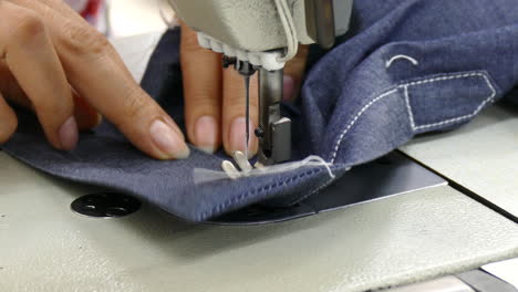 close-up-on-sewing-machine-working-with-jeans