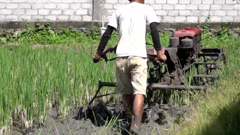 SLOW-MOTION-Barefoot-Man-Operating-Rice-Field-Tractor