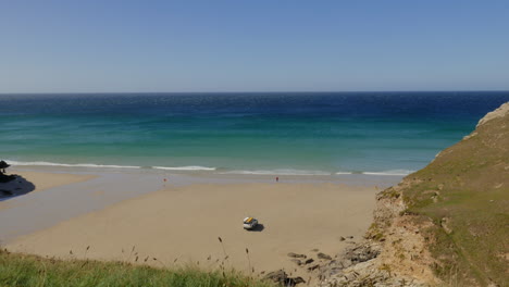 Blick-Von-Der-Klippe-Auf-Den-Strand-Von-Cornwall-Mit-Wunderschönen-Wellen-Mit-Türkisfarbenen,-Blauen-Und-Grünen-Farben,-Schwenk