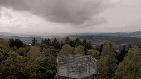 Aerial-view-of-the-Sauerland-region-in-Germany-revealing-the-steel-construction-lookout-point-on-top-of-the-Wilzenberg-catholic-pilgrimage-mountain