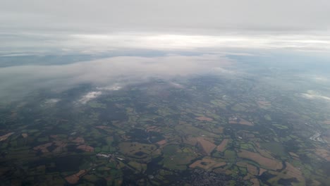 High-altitude-british-landscape-overcast-day-view-from-airplane-window