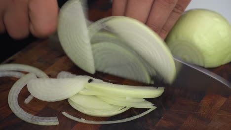 chopping-onions,-fast-cutting-onions-on-wooden-cutting-board,-chef-cutting-onions-julienne-style