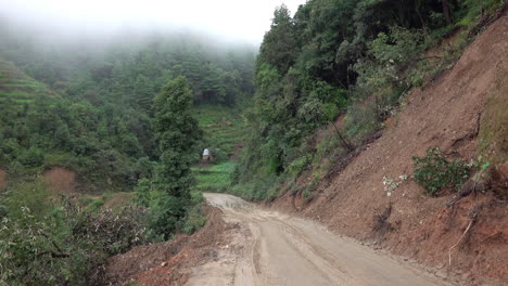 An-empty-muddy-road-in-the-foothills-of-the-Himalayas-of-Nepal