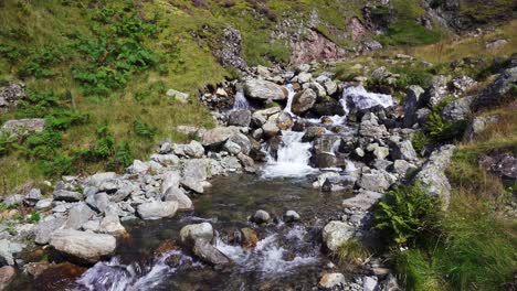 Fast-flowing-mountain-stream-cascading-down-the-side-of-a-mountain