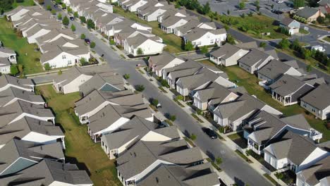 Slow-aerial-turn-reveals-hundreds-of-identical-homes,-new-construction,-built-in-US-suburban-sprawl