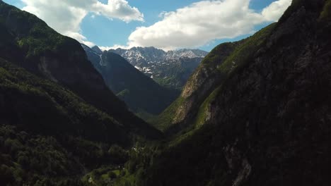 Forward-drone-shot-of-slovenian-mountains,-on-a-sunny-day-with-some-clouds