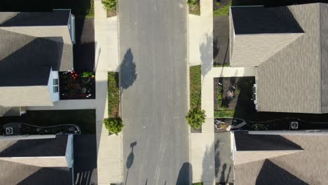 Aerial-top-down-birds-eye-drone-view-of-homes-along-quiet-street-in-suburbia