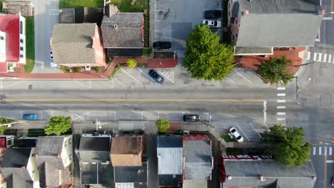 Aerial-top-down-birds-eye-drone-view-of-cars-at-4-way-street-intersection-at-traffic-light-in-USA