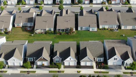 Slow-aerial-tilt-up-revealing-identical-homes-in-suburban-America,-USA,-identical-homes-in-summer-sunlight