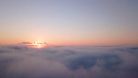 Aerial-dreamy-and-scenic-view-at-sunrise-low-above-the-clouds
