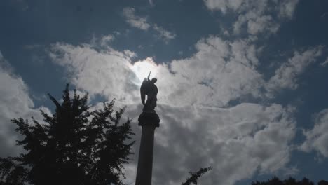 Timelapse-of-sun-moon-passing-behind-cemetary-statue-on-pillar