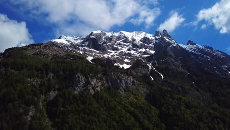 Sliding-drone-shot-of-slovenian-mountains,-on-a-sunny-day-with-some-clouds