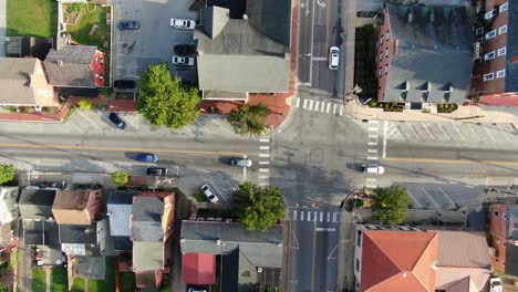 Aerial-slow-truck-shot-of-traffic-passing-through-intersection-at-traffic-light-in-USA