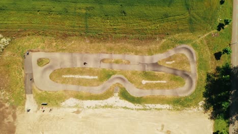 Aerial-view-of-people-racing-on-a-bicycle-pump-track-in-Spisska-Bela,-Slovakia