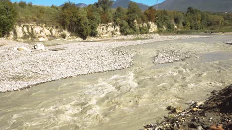 muddy-water-flowing-into-the-riverbed-eroding-it