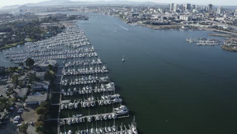 Pan-up-across-a-large-marina-and-sailboats-parked-in-their-slips