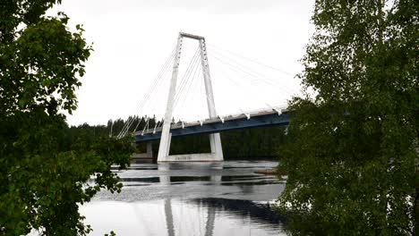 Cinematic-sequence-of-bird-flying-by-in-slow-motion-as-single-car-drives-over-Cable-bridge-in-deserted-Northern-Sweden