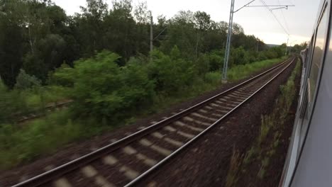 A-view-of-the-train-tracks-and-the-woods-from-a-fast-moving-train