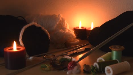 Cozy-background-of-a-knitting-table-with-candles-and-knitting-equipment
