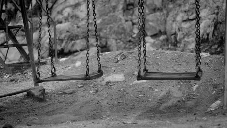 Black-and-white-video-of-Swing-swinging-by-itself-in-park-concept-of-paranormal-activity