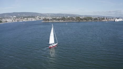 A-sailboat-slowly-slips-along-as-the-camera-pans-up-to-reveal-the-bay
