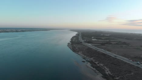 Aerial-view-during-sunset-of-a-natural-reserve-and-its-river