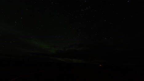Timelapse-of-amazing-northern-lights-filmed-in-Iceland-with-cars-passing-in-foregroung