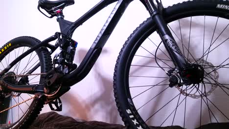 A-slow-pan-up-to-reveal-a-professional-black-mountain-bicycle-with-full-suspension-and-hydraulic-disc-brakes